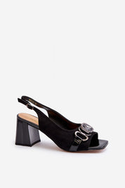 Mirellise black suede heel sandals with decorative detail and adjustable ankle strap, featuring a stable post heel.