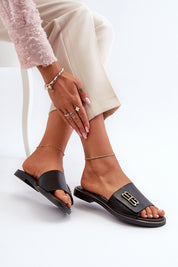 Alt Tag: Tavirelle Gold Trim Leather Slides showcased with anklets, highlighting the sleek leather design and elegant gold accent.