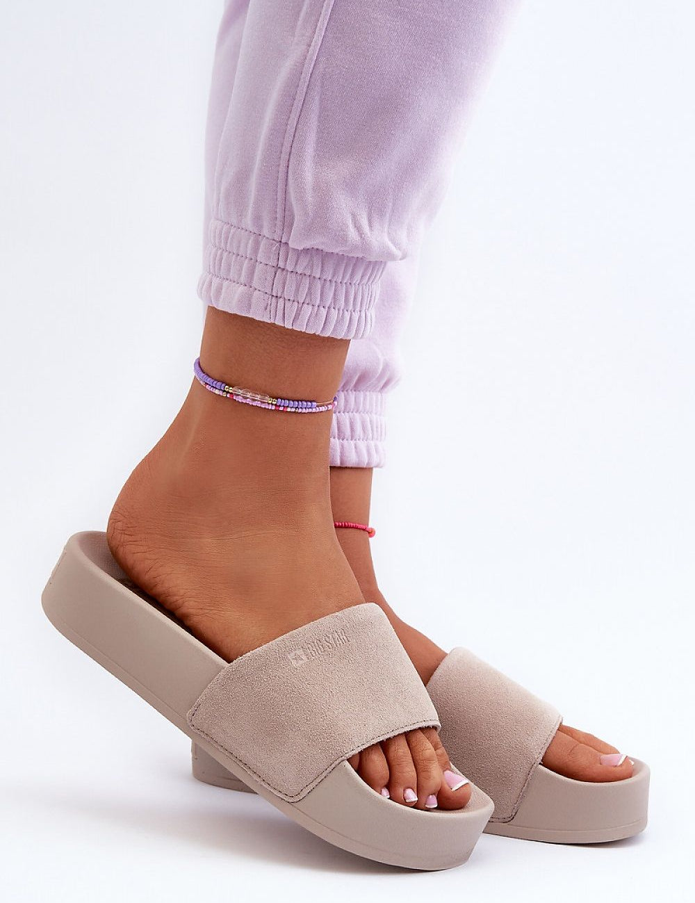 Zanurea Suede Platform Slide Sandals on foot showcasing wide suede strap and solid platform base for a stylish, comfortable look.