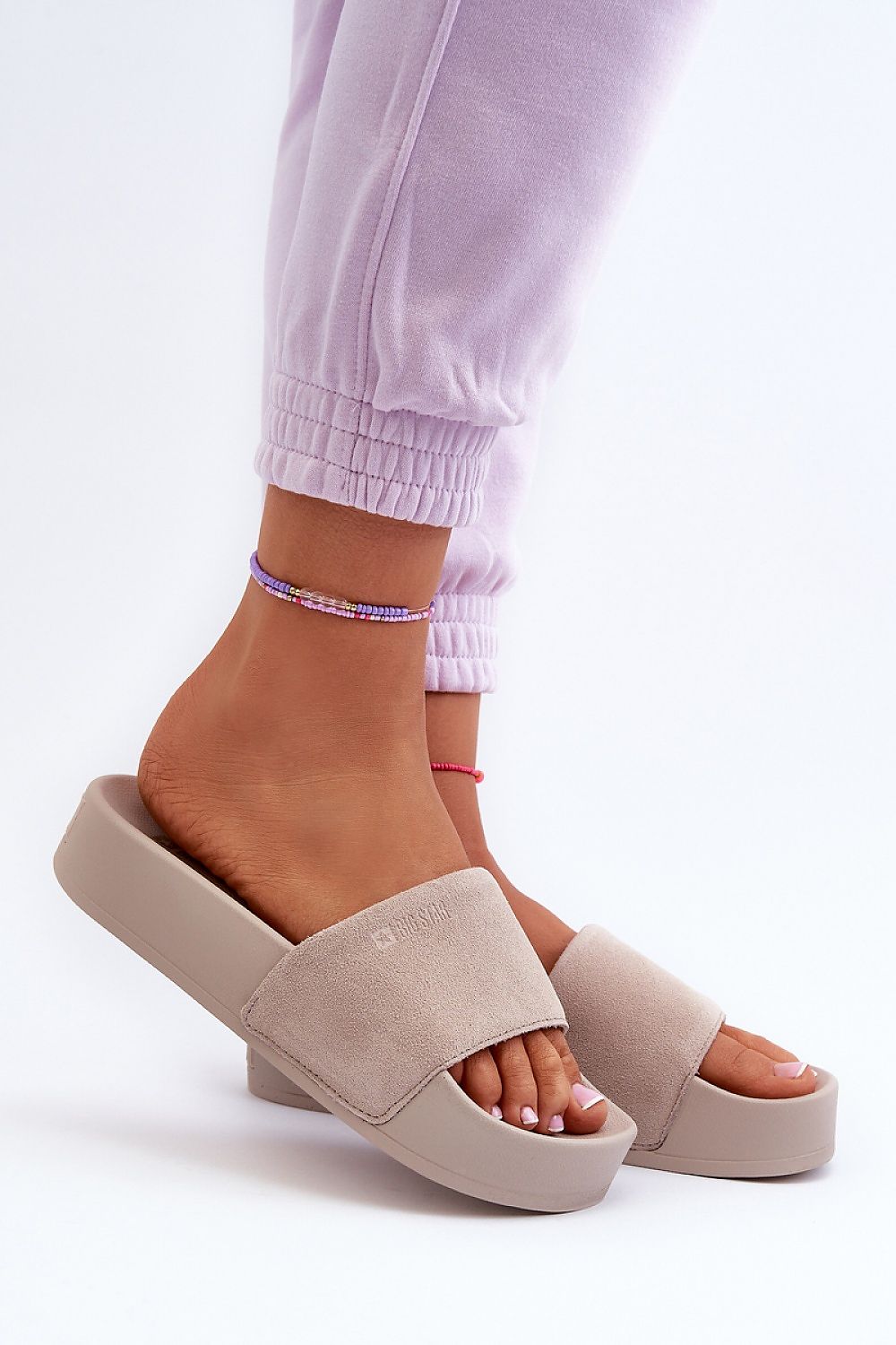 Zanurea Suede Platform Slide Sandals on foot showcasing wide suede strap and solid platform base for a stylish, comfortable look.