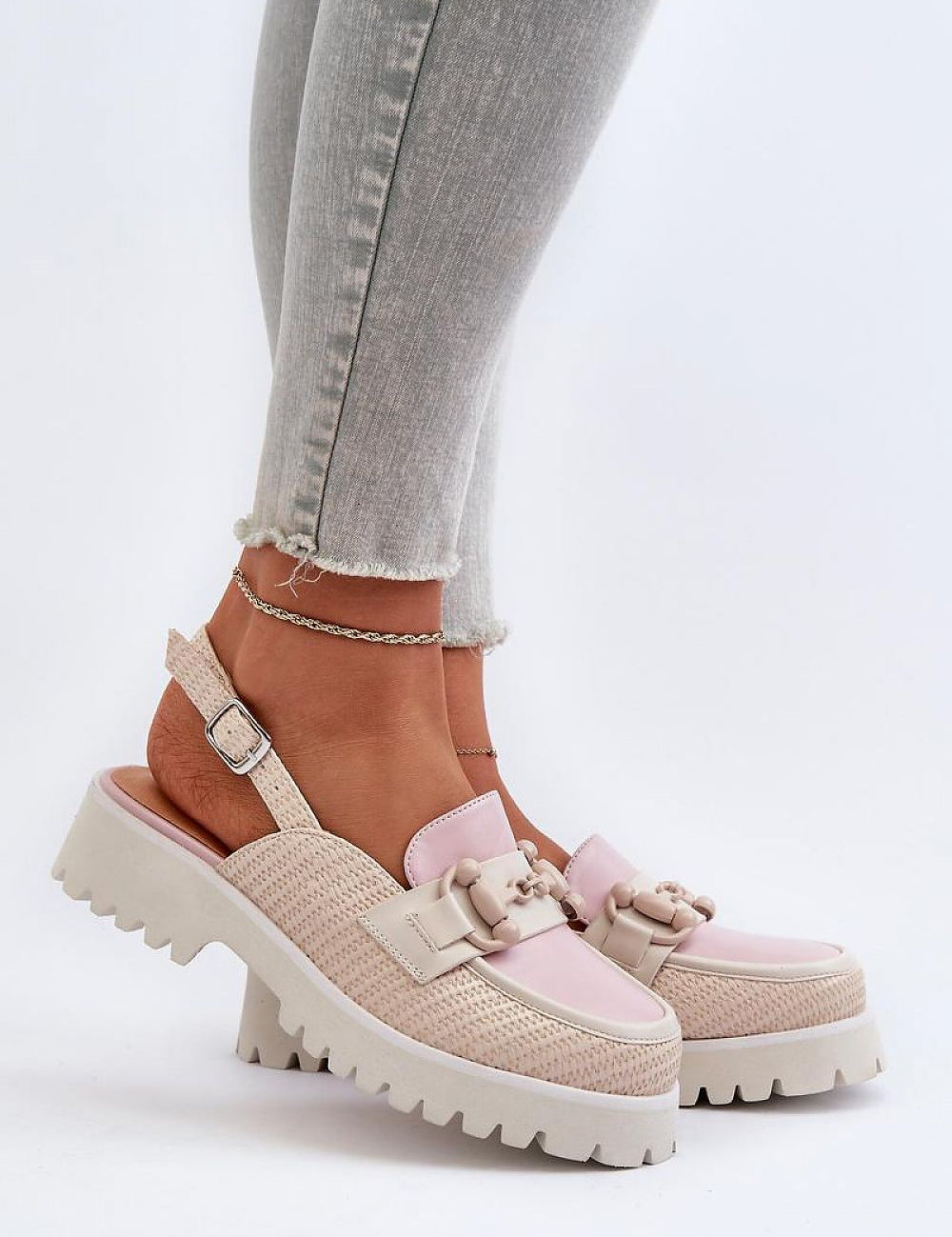 Woman wearing Larivena Buckled Low Platform Sandals in pink and beige eco leather with adjustable buckle and contoured insole.