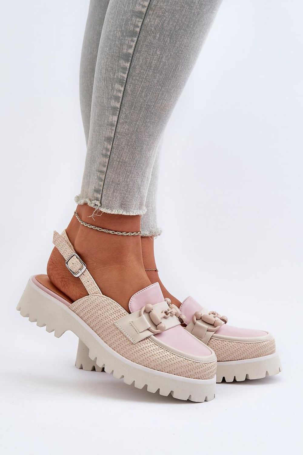 Woman wearing Larivena Buckled Low Platform Sandals in pink and beige eco leather with adjustable buckle and contoured insole.