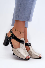 Woman wearing Esmira Post Heel Strap Sandals in eco leather, featuring adjustable buckle and cushioned insole for comfort.