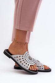 Light pink trousers paired with Orletta flat slides featuring cutout eco leather upper and low heel for comfort and style.