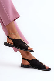Woman wearing Veralya suede sandals with gold accent and adjustable ankle straps.