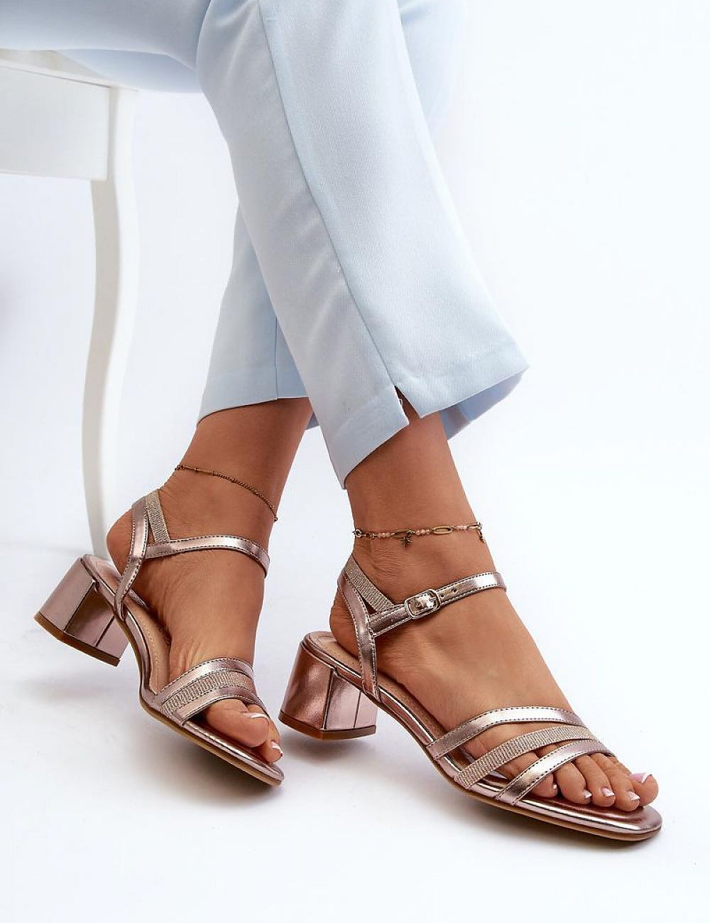 Woman wearing Sylviane Triple Strap Heel Sandals with block heel and adjustable ankle strap, featuring eco leather finish.