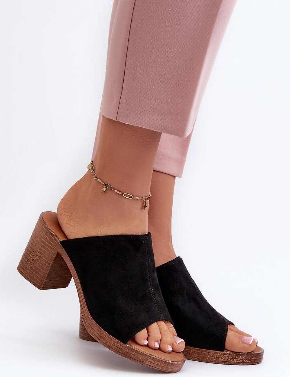 Person wearing Myrravea Soft Suede Wedge Slides in black, showing the stylish suede-like upper and comfortable wedge heel.