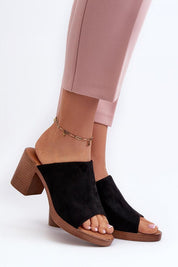 Person wearing Myrravea Soft Suede Wedge Slides in black, showing the stylish suede-like upper and comfortable wedge heel.