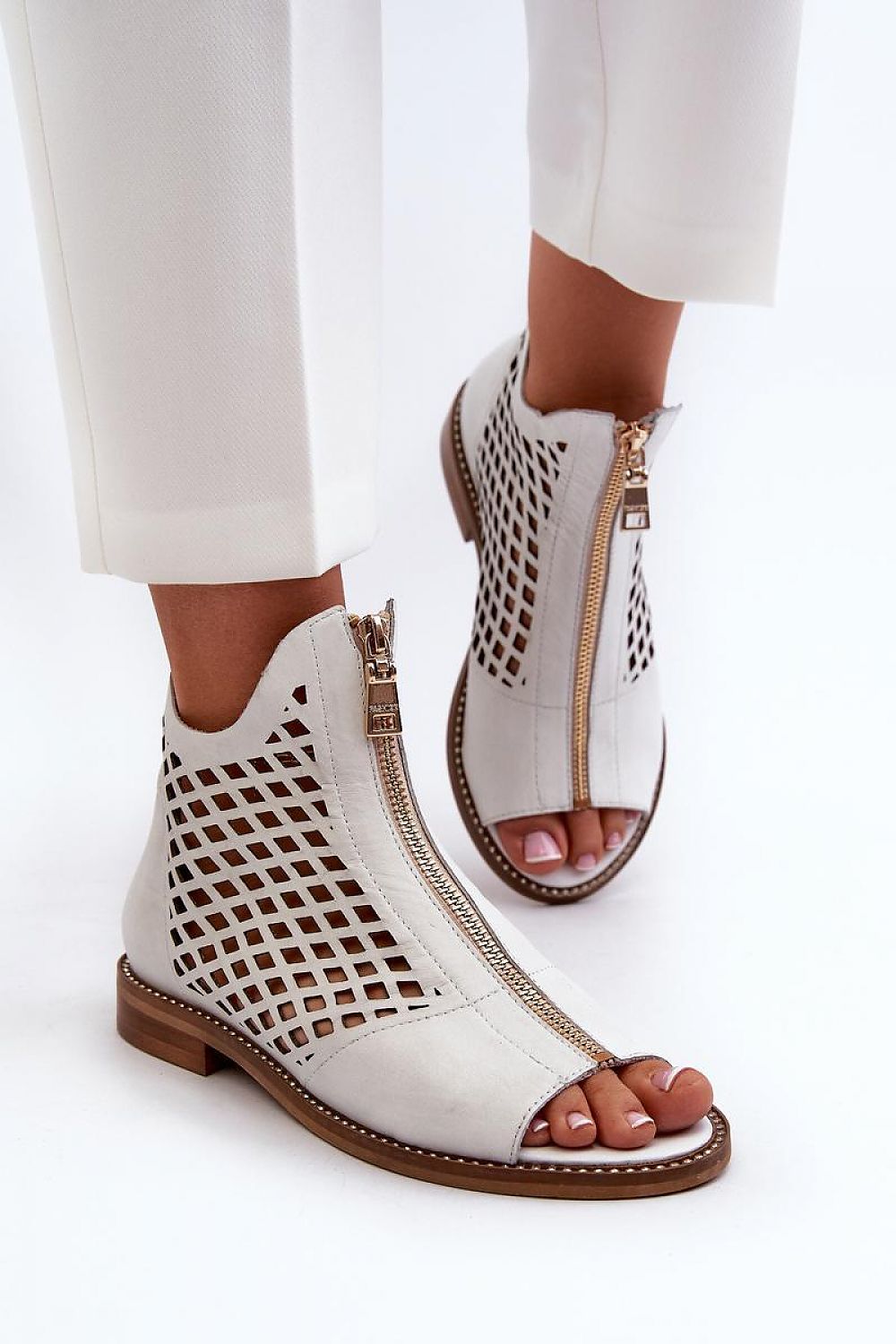 Almeryn Zipped Openwork Flat Sandals in white leather with front zipper and openwork design, featuring soft sole and subtle zircon detail.
