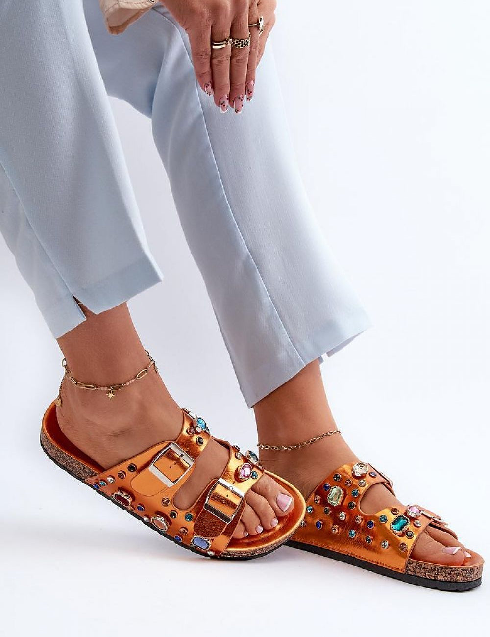 Woman wearing Merelina Crystal Buckle Platform Slides with eco leather and crystal embellishments, featuring a cork-inspired platform.