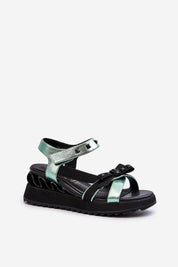 Aurelline Strap Bow Wedge Sandals with green artificial leather upper, black wedge heel, and bow detail, featuring Velcro closure.