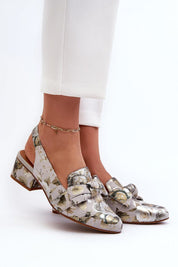 Woman wearing Elviera Floral Leather Heel Sandals with subtle floral pattern and ankle strap for a romantic, elevated look.