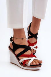 Woman wearing Seranta Braided Sole Wedges with eco leather and suede-like straps, featuring a high wedge and adjustable ankle strap.