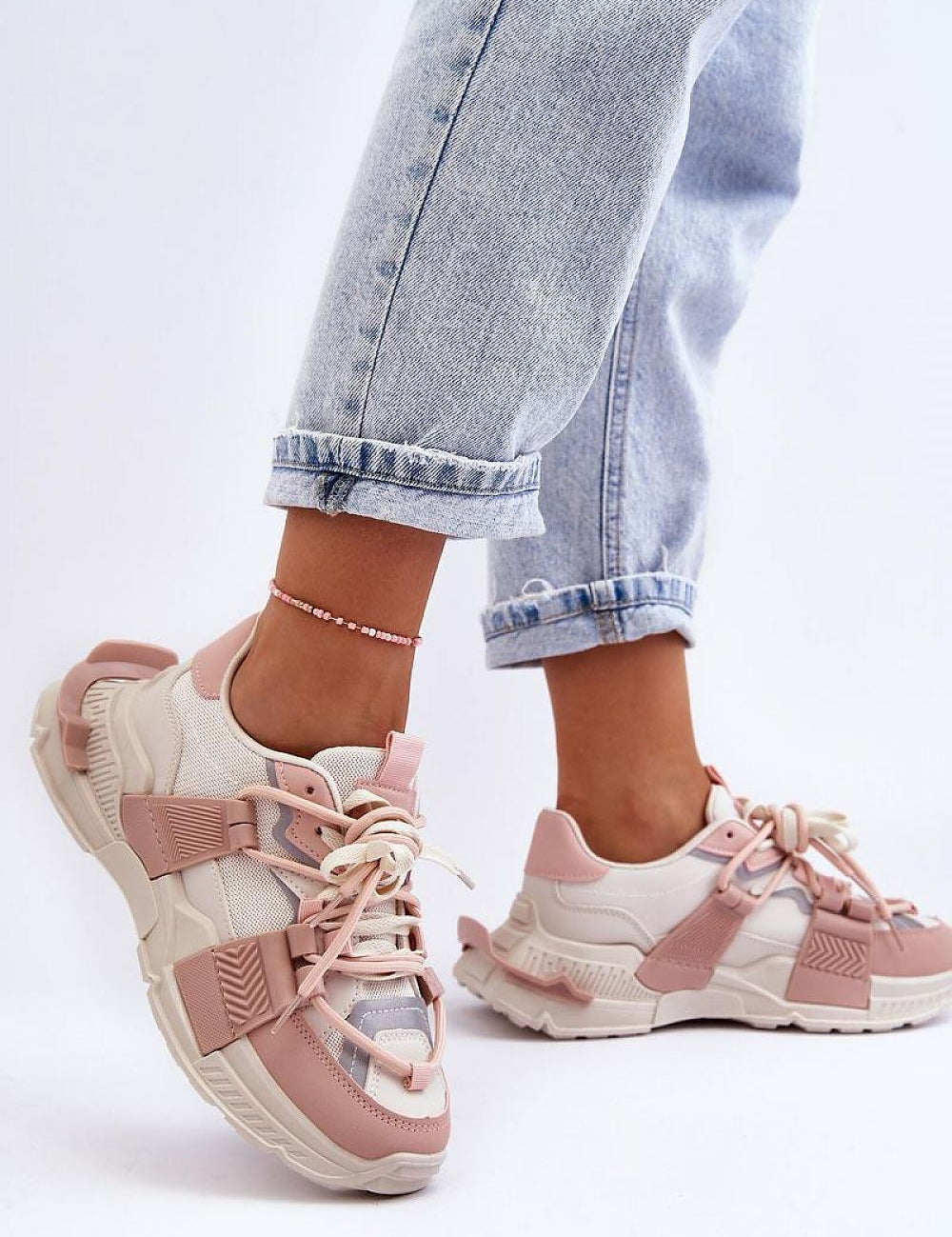 Person wearing pink and white Ravetta Urban Platform Sneakers with jeans showcasing eco leather design and bold silhouette.