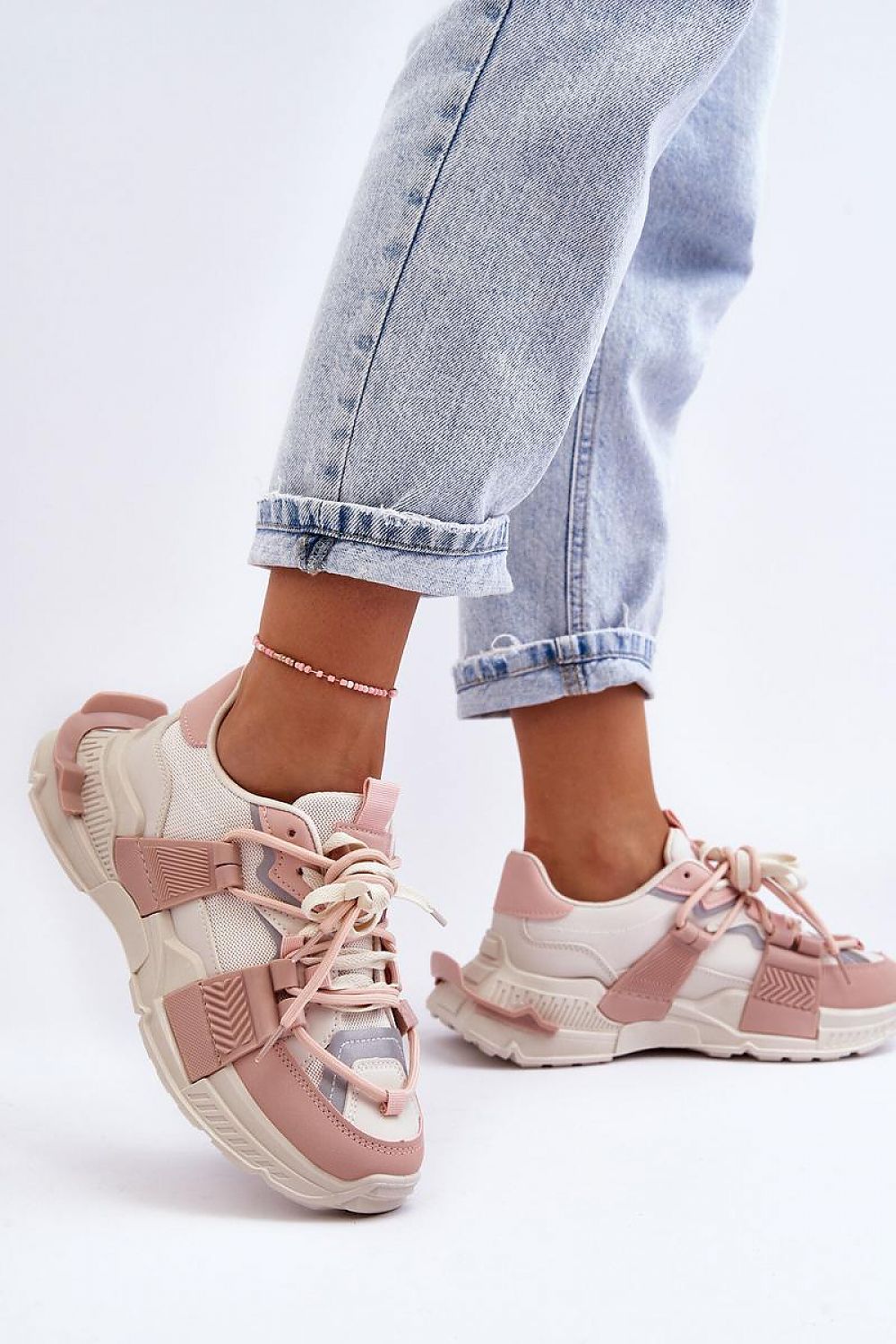 Person wearing pink and white Ravetta Urban Platform Sneakers with jeans showcasing eco leather design and bold silhouette.