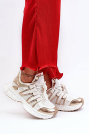 Person wearing Astaria thick-soled street sneakers with white and metallic accents paired with red pants for an urban look.