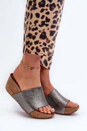 Woman wearing Mirano leather wedge flip-flops with cork-style wedge and silver straps, paired with leopard print pants.