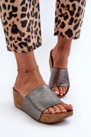 Woman wearing Mirano Leather Wedge Flip-Flops paired with leopard print pants, featuring cork-style wedge and sleek design.