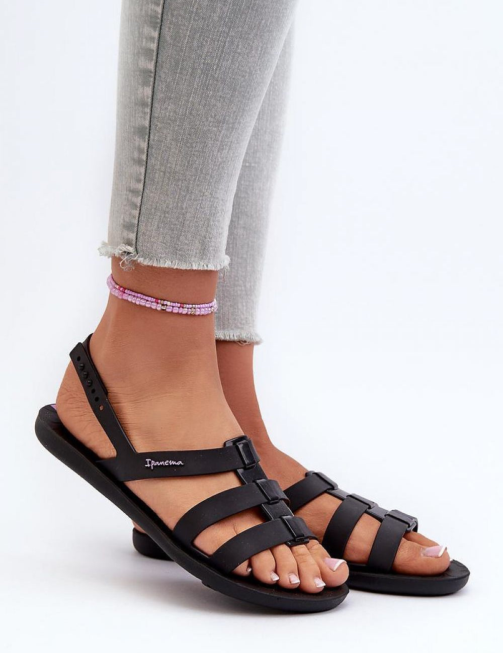 Person wearing Arvia Buckled Poolside Sandals with adjustable buckle straps and lightweight rubber construction, perfect for summer.