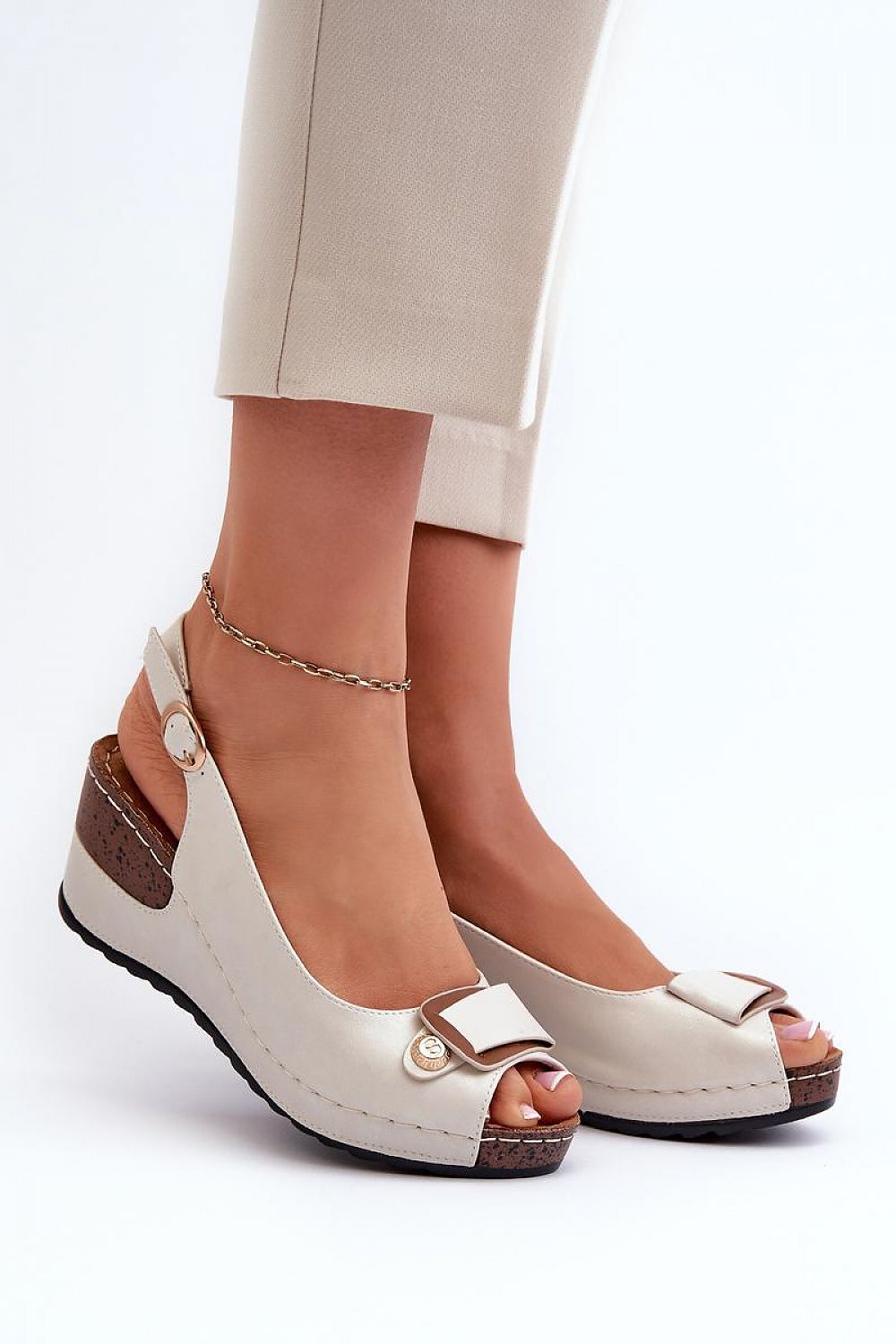 Woman wearing Vesmira Lifted Comfort Wedges with eco leather straps and cushioned insole, side view of beige wedge sandals.