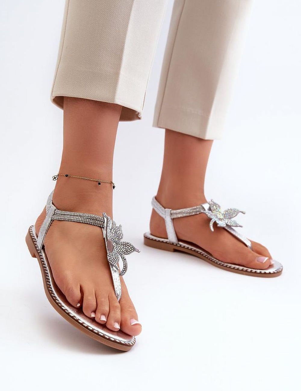 Woman wearing Elavie Blossom Accent Flats with floral details, soft synthetic finish, and open design for summer elegance.