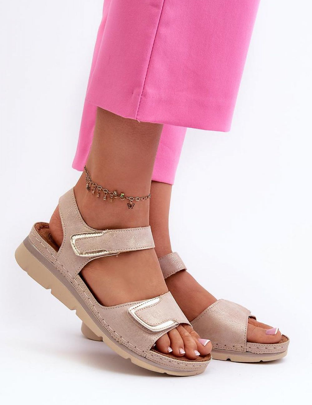 Velmera Lightweight Strap Sandals in beige with Velcro fastening, worn by a person in pink pants, showing comfort and style.