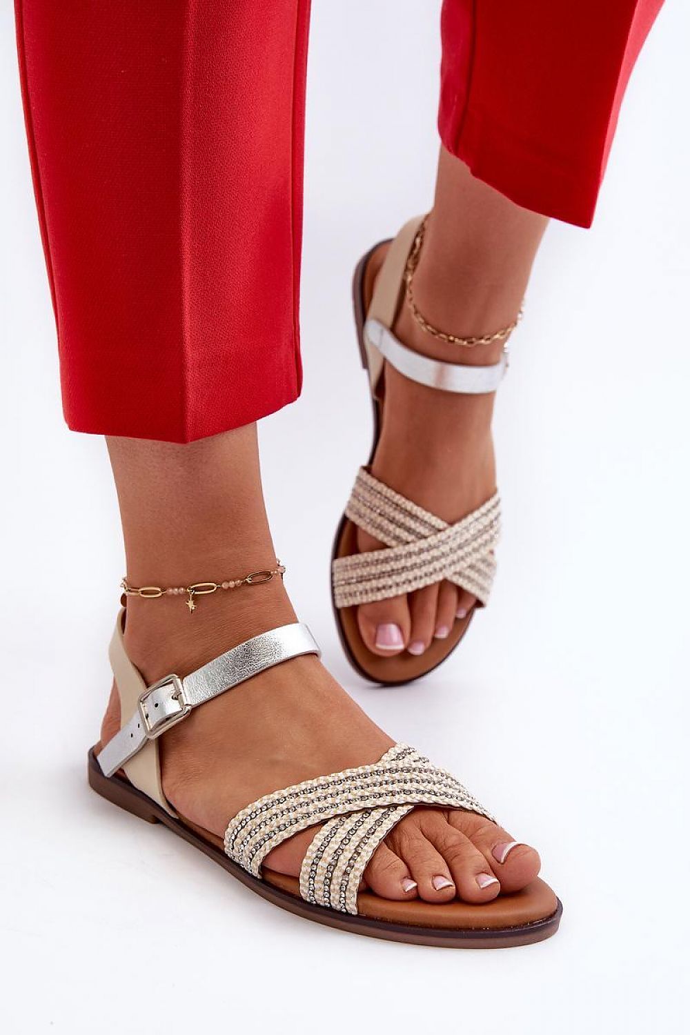 Eco leather minimal strap sandals with flat sole and adjustable buckle, perfect for summer wear, worn with red pants.