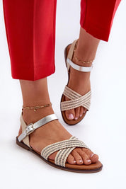 Eco leather minimal strap sandals with flat sole and adjustable buckle, perfect for summer wear, worn with red pants.