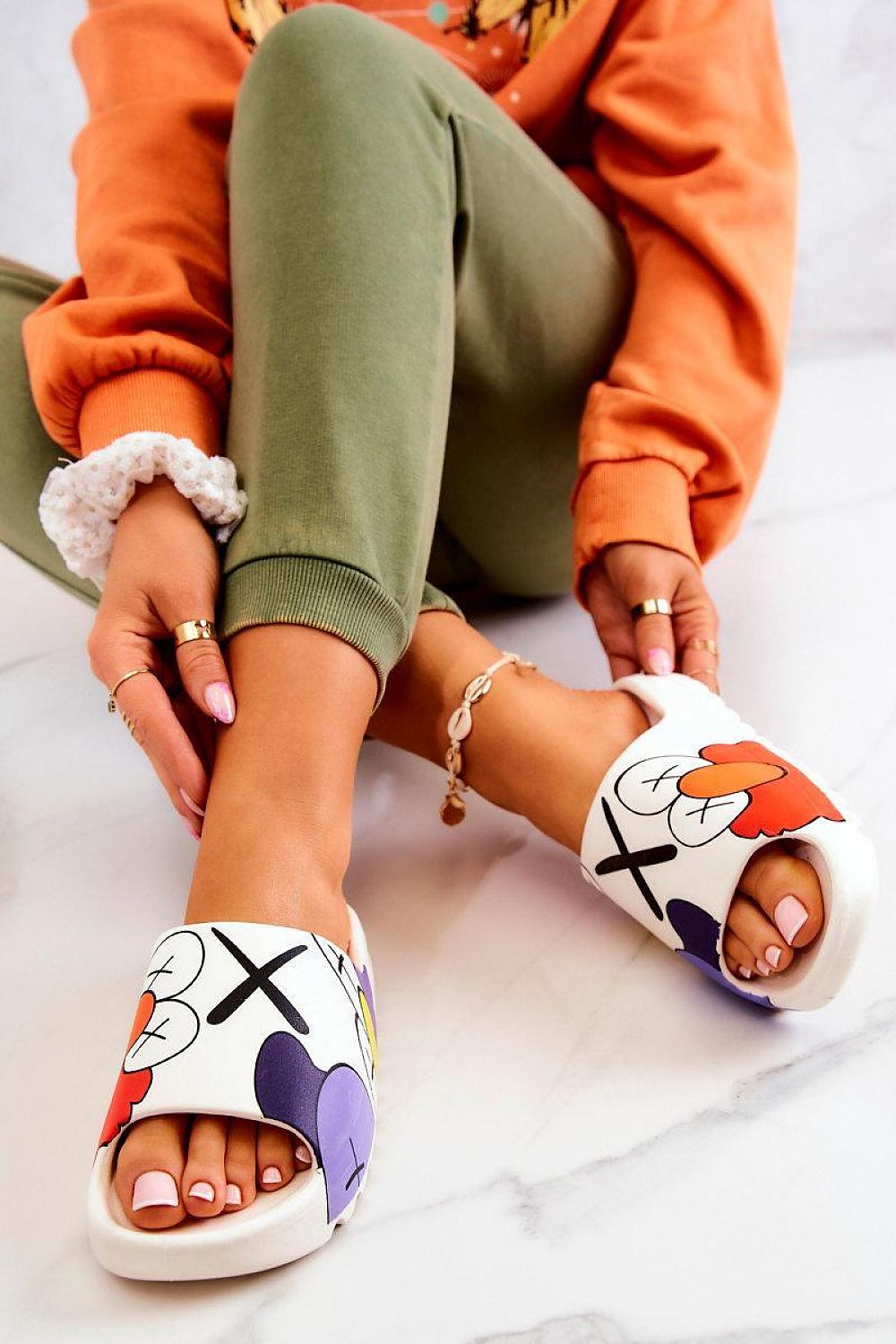 Woman wearing Mifla Cartoon Rubber Summer Slides with vibrant design, showcasing playful comfort and style on a marble floor.