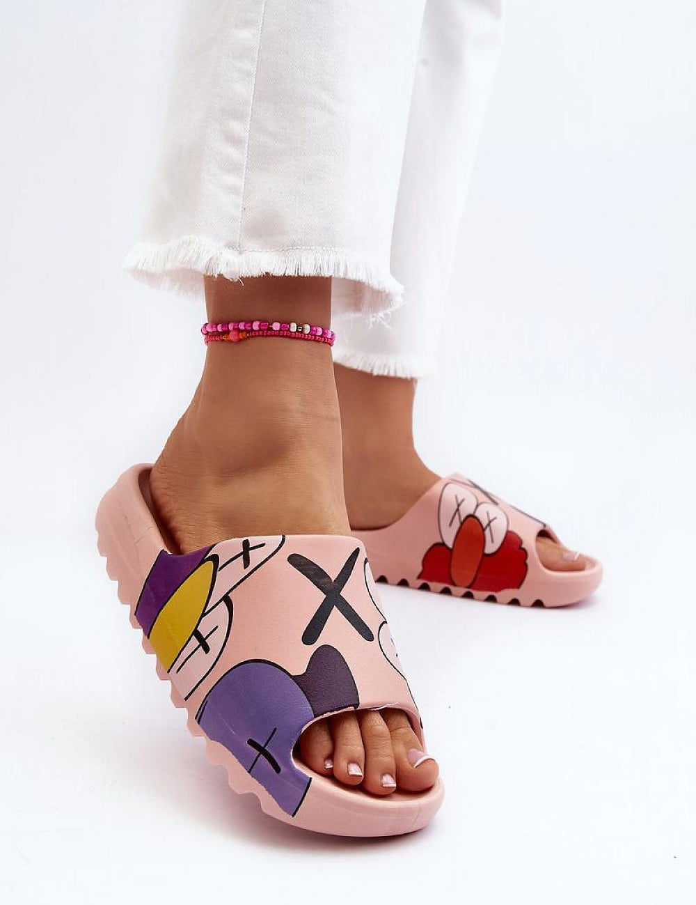 Mifla Cartoon Rubber Summer Slides in pink with vibrant print, flexible rubber, worn by person in white pants, showcasing playful design.