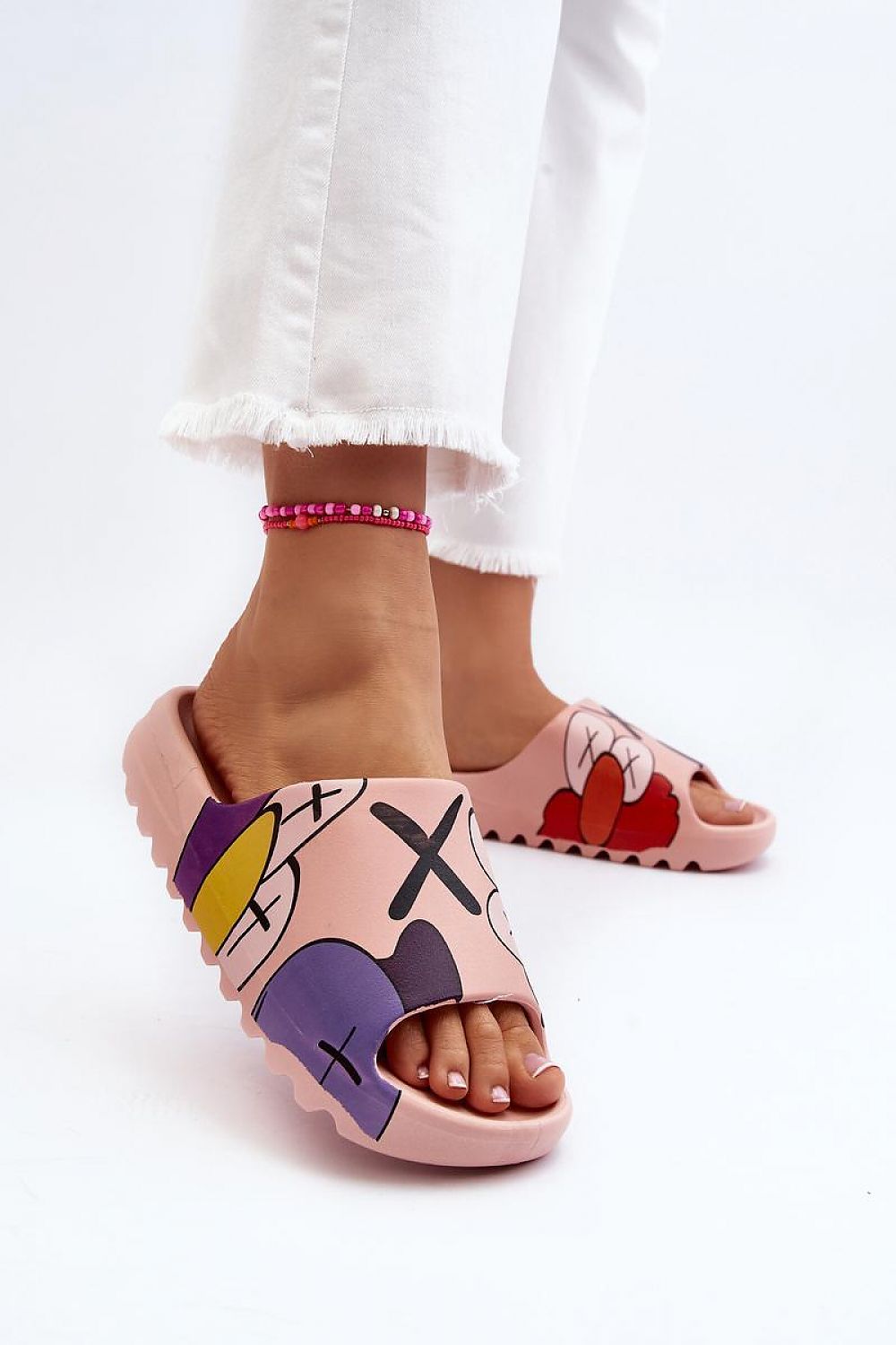 Mifla Cartoon Rubber Summer Slides in pink with vibrant print, flexible rubber, worn by person in white pants, showcasing playful design.