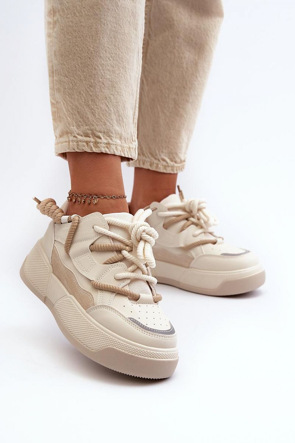 Velenta modern platform sneakers in beige, featuring smooth artificial leather uppers, worn with casual pants for a stylish look.