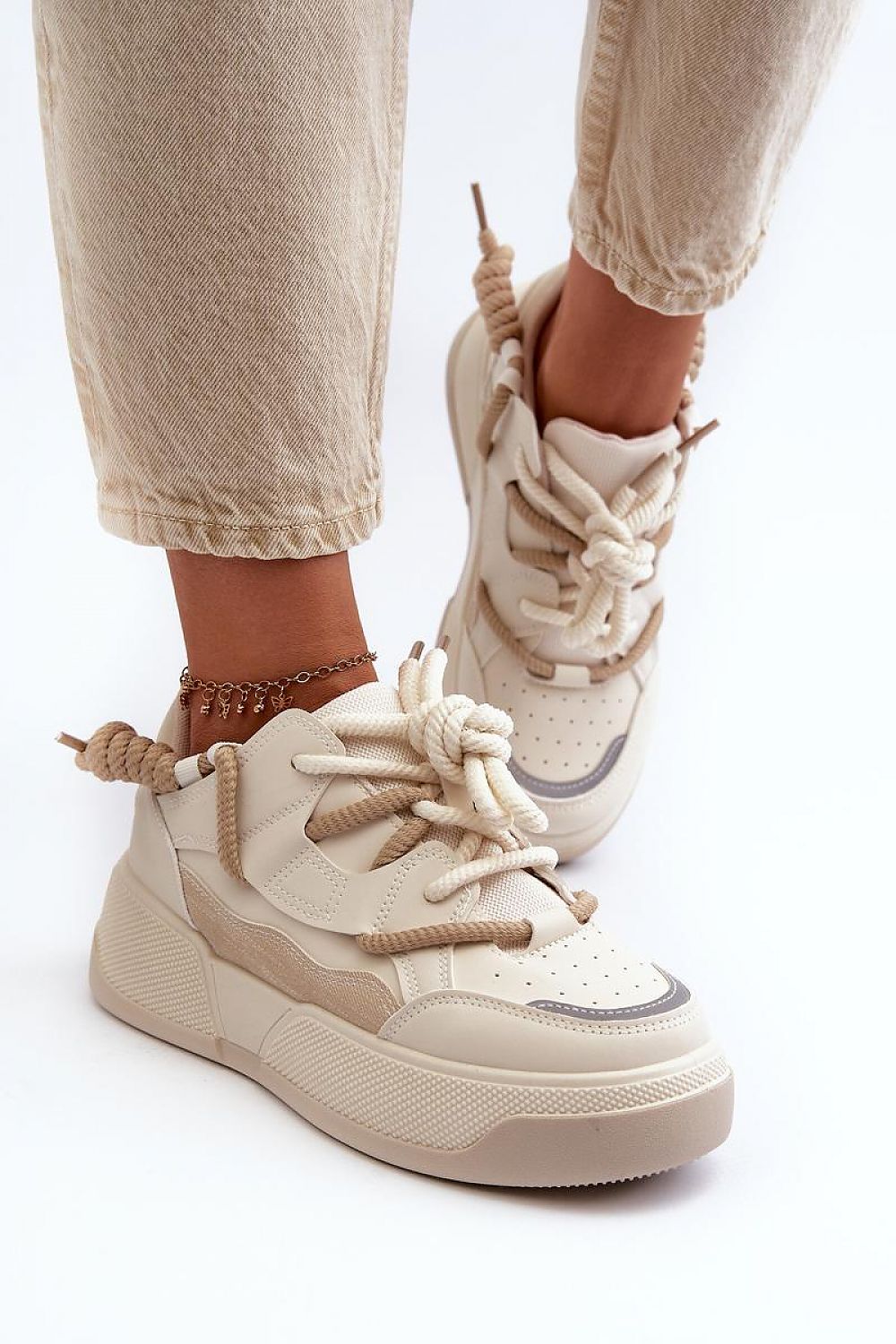 Velenta modern platform sneakers on feet with light pants, showcasing beige artificial leather and stylish design.