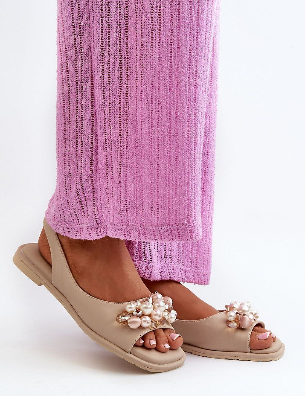 Woman wearing Rensola Minimalist Flat Sandals with pearl accents, showcasing eco leather design and elastic back strap.