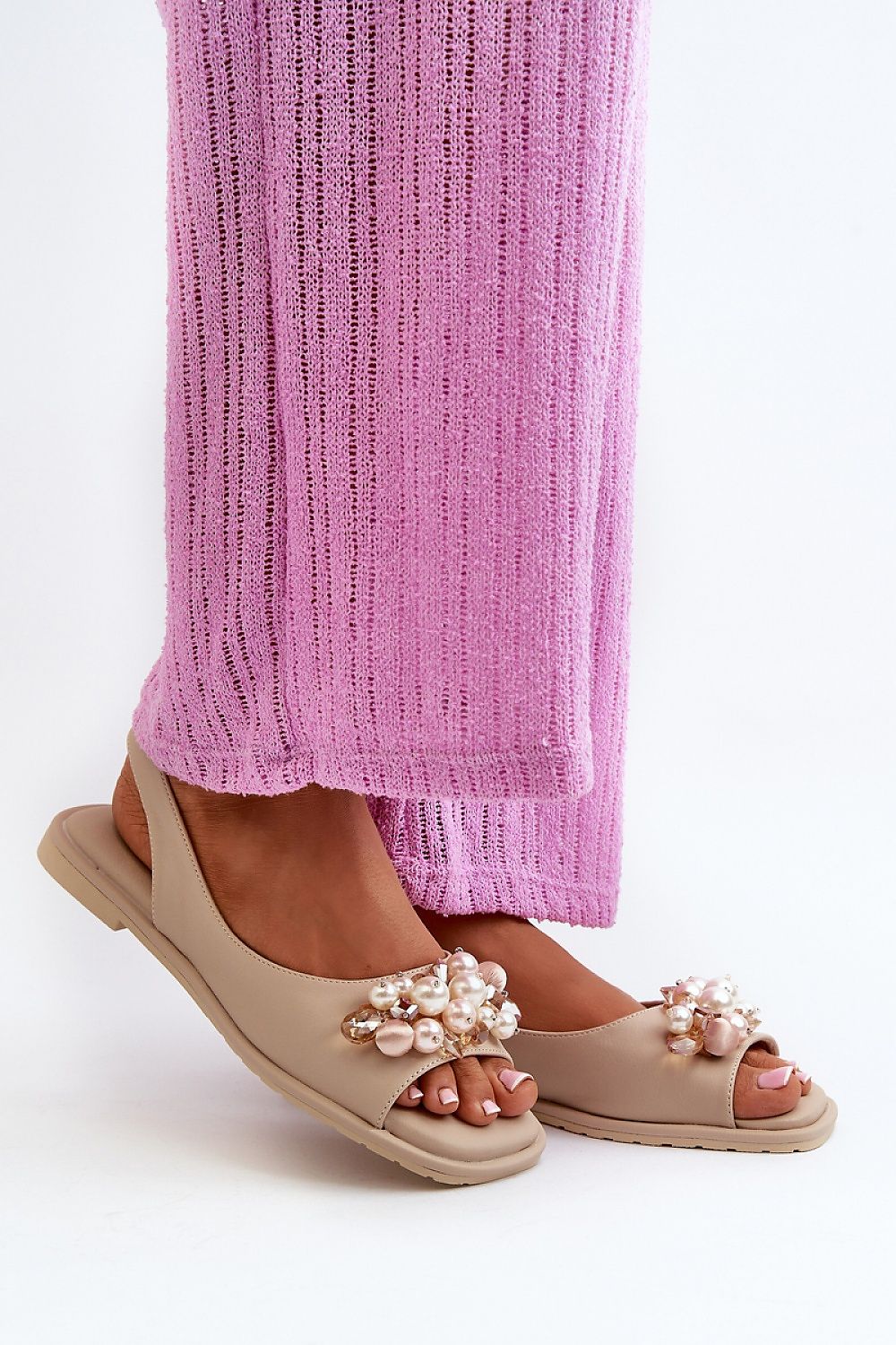 Woman wearing Rensola Minimalist Flat Sandals with pearl accents, showcasing eco leather design and elastic back strap.