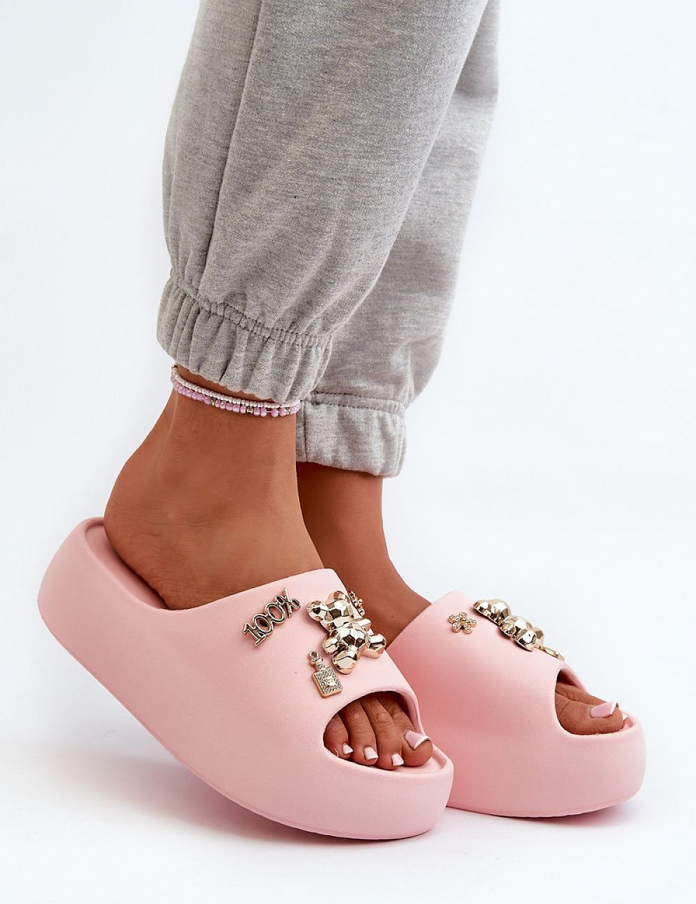 Person wearing pink Floriva Thick-Sole Foam Flip-Flops with decorative accents and sturdy platform, perfect for beach days and casual outfits.