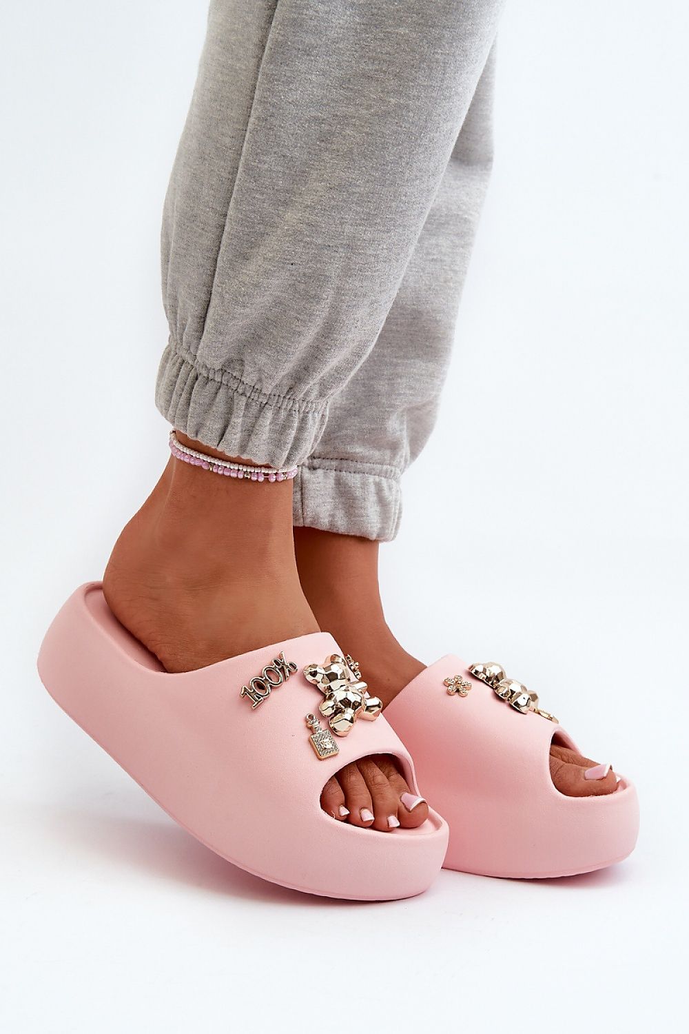 Person wearing pink Floriva Thick-Sole Foam Flip-Flops with decorative accents and sturdy platform, perfect for beach days and casual outfits.