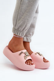 Person wearing pink Floriva Thick-Sole Foam Flip-Flops with decorative accents and sturdy platform, perfect for beach days and casual outfits.