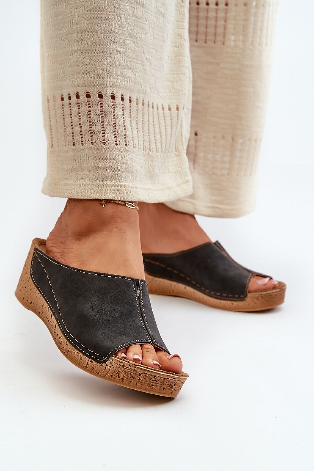 Woman wearing Solenca Soft Arch Flip-Flops with faux leather upper and wedge soles for comfort and style.