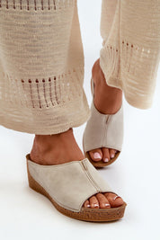 Woman wearing Solenca Soft Arch Flip-Flops with faux leather and suede insole, paired with beige crochet pants.