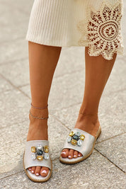 Model wearing Velinor Decor Flat Sandals with decorative accents and leather insole, perfect for summer styling.