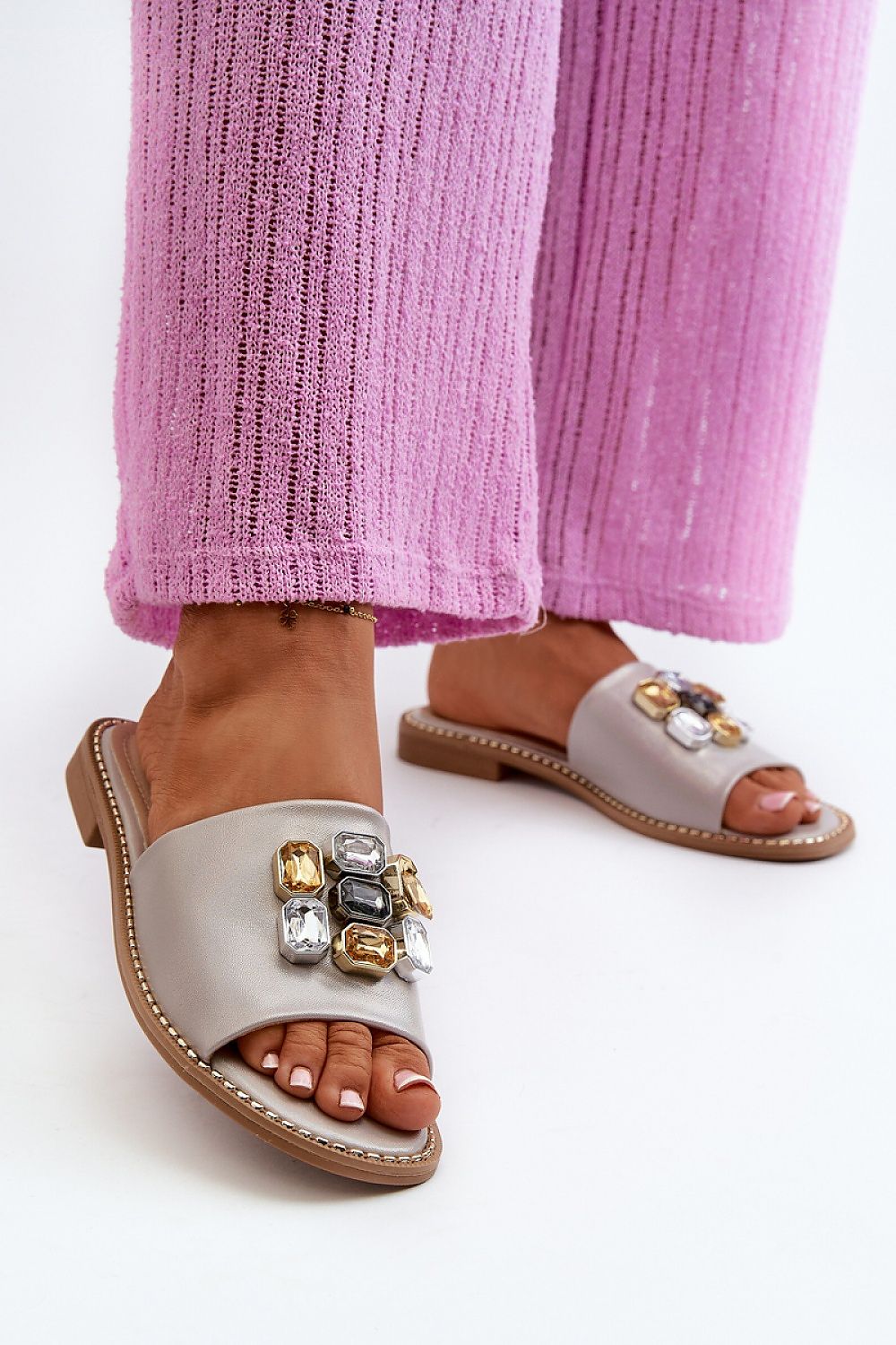 Velinor Decor Flat Sandals with glossy synthetic upper, decorative accents, and leather insole for summer; worn with pink pants.