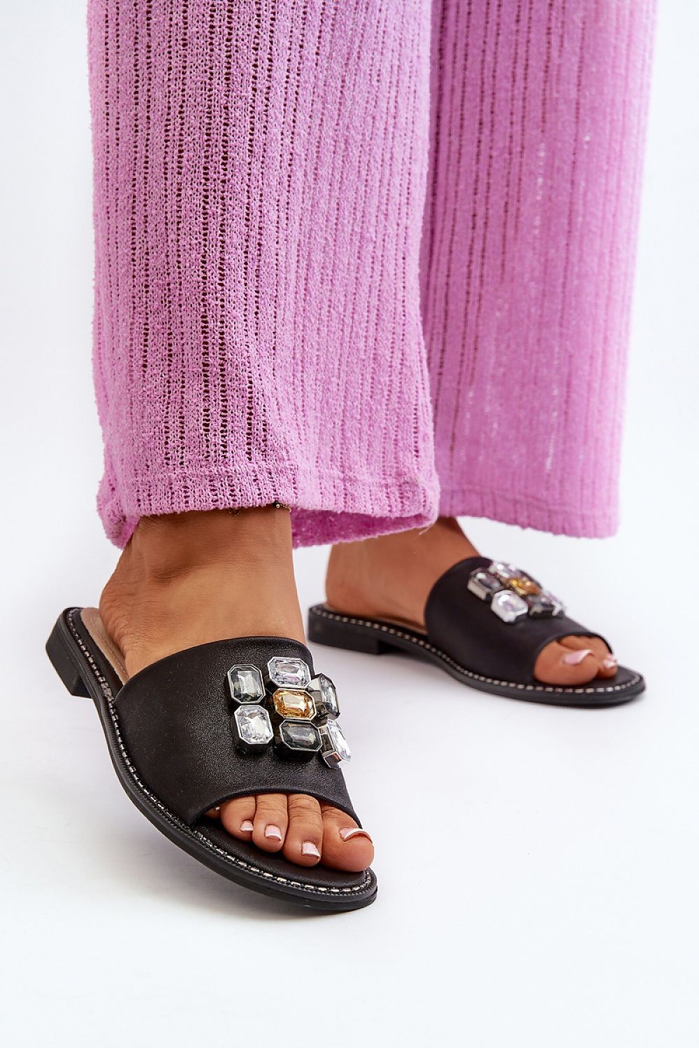 Velinor Decor Flat Sandals with glossy synthetic upper and embellishments, worn with pink pants for stylish summer fashion.