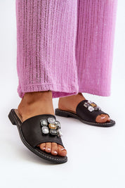 Velinor Decor Flat Sandals with glossy synthetic upper and embellishments, worn with pink pants for stylish summer fashion.