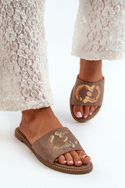 Woman wearing Naerelle Suede Spark Flip-Flops with sequin straps, paired with lace pants, showcasing a chic summer style.
