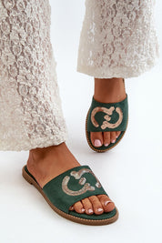 Woman wearing Naerelle Suede Spark Flip-Flops with sequin detail, paired with white lace pants, showcasing a casual summer look.