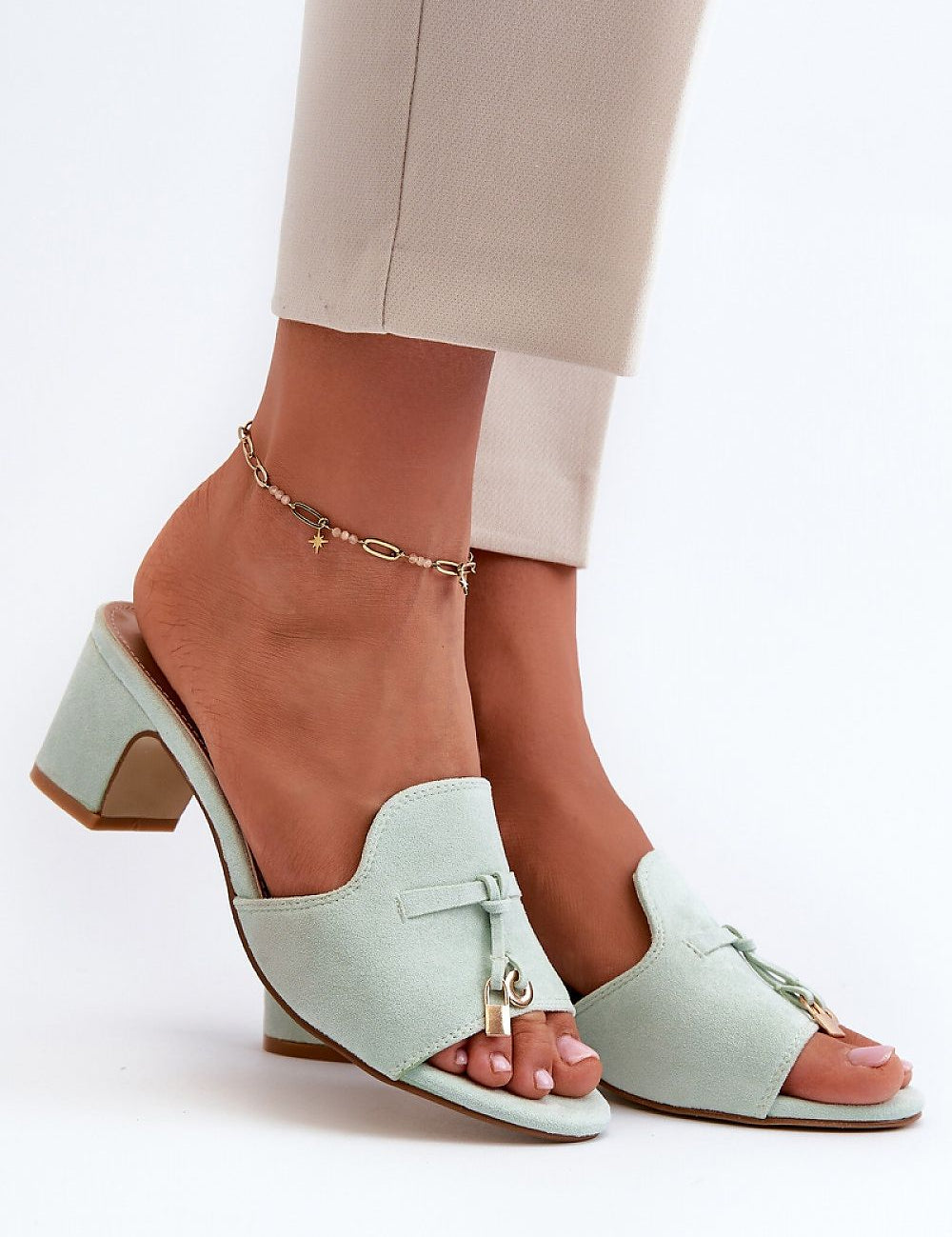 Mint green Solvera heeled suede flip-flops with 5.5 cm heel on foot, showcasing a chic, minimalist summer style for casual or dressy outfits.