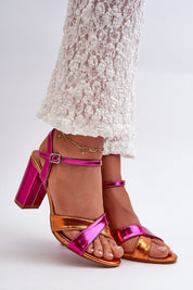 Colorful cross-strap heeled sandals with ankle buckle, worn with lace pants for a stylish summer look