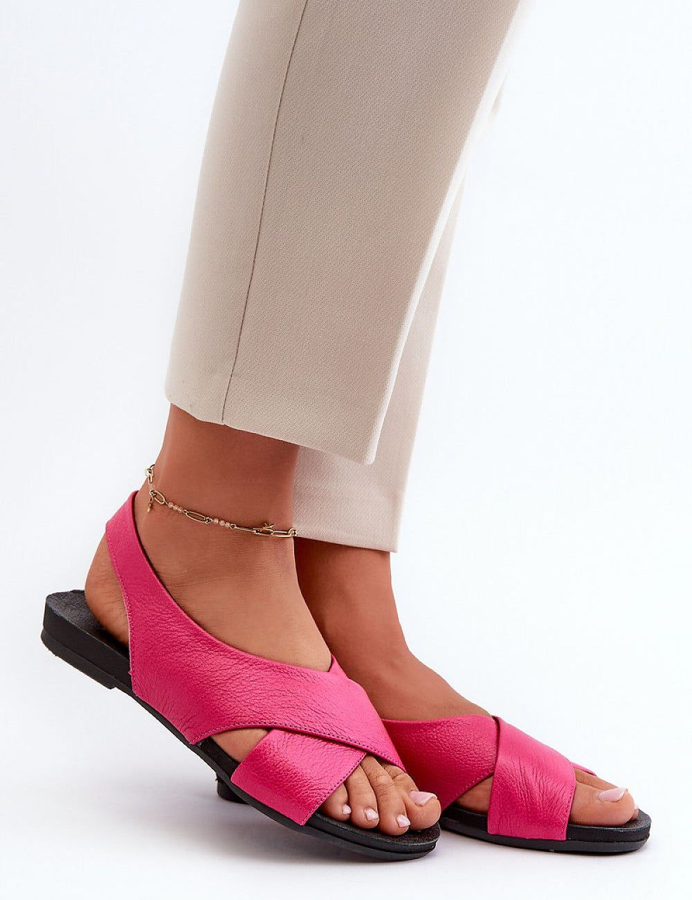 Woman wearing Talmea Soft-Strap Leather Sandals in pink, showing open heel and toe design for breathability and comfort.