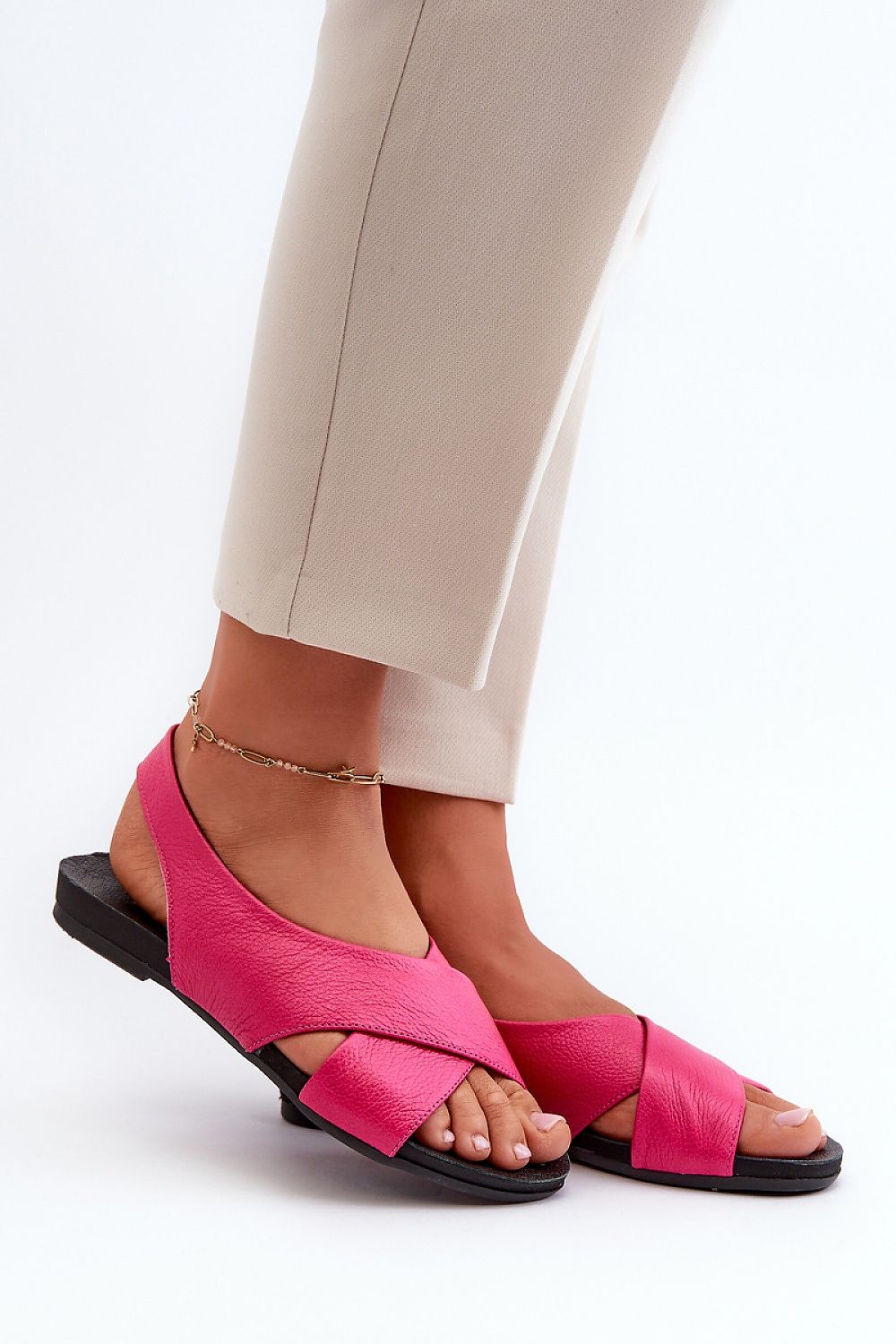 Woman wearing Talmea Soft-Strap Leather Sandals in pink, showing open heel and toe design for breathability and comfort.